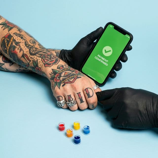 Client confirming a deposit payment in a tattoo studio